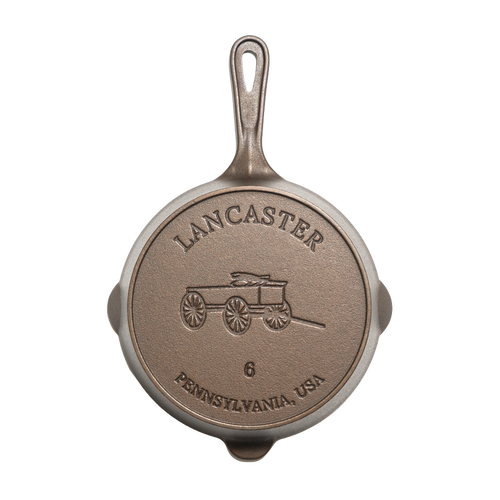 Bottom view of a handcrafted, lightweight cast iron skillet embossed with a horse-drawn wagon and marked size 6, made in the USA for Kitchen & Food, Camping, and Cast Iron collections.