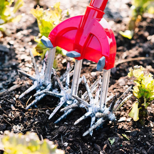 Close-up of Original Garden Weasel’s rust-proof, serrated tines with red comfort-grip handle, designed for loosening hard soil and uprooting tough weeds, featured in Farm, Garden & Tool and Digging and Cultivating collections.