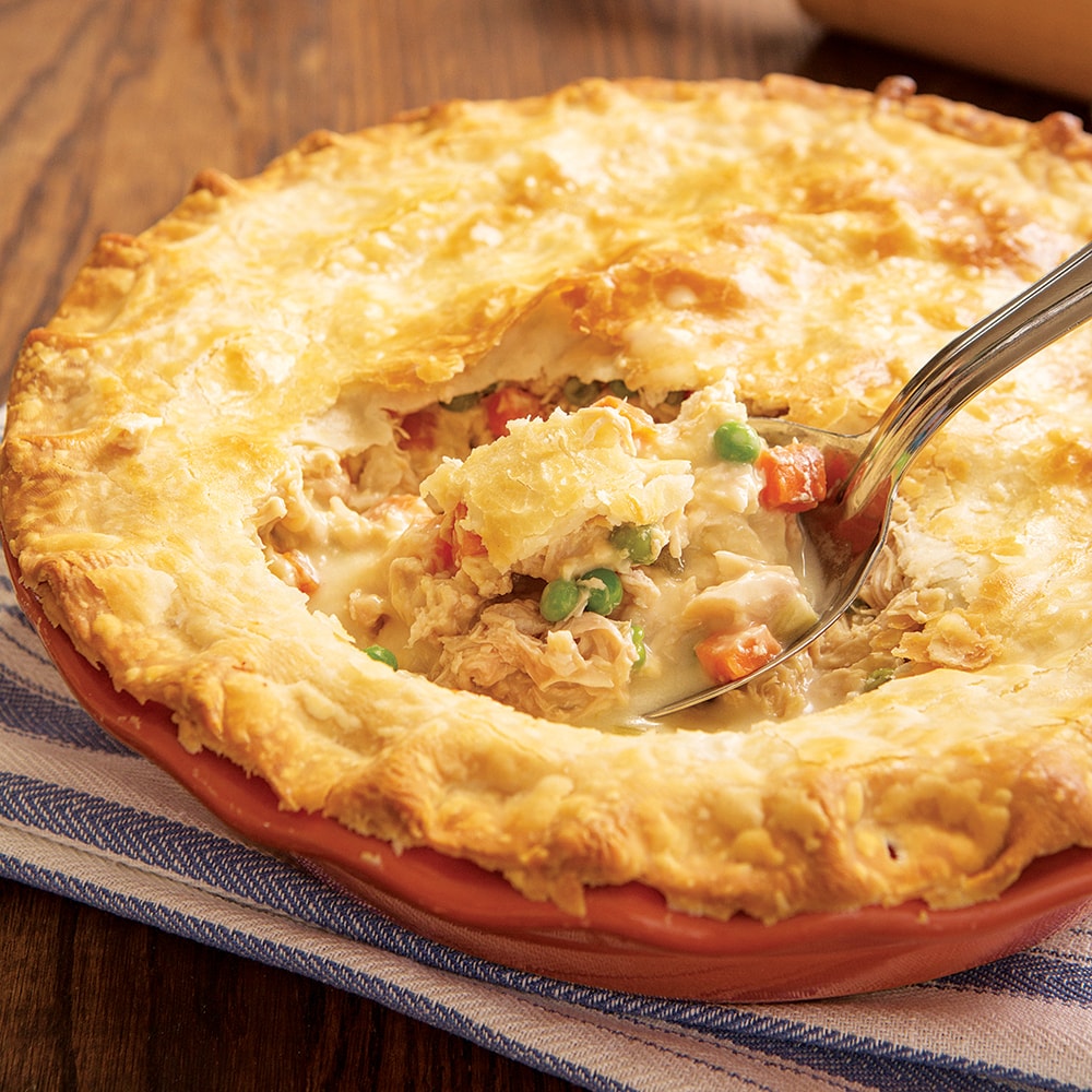 Golden-brown homemade turkey pot pie filled with creamy shredded turkey, peas, and carrots served on a wooden table, highlighting a hearty meal from Farm, Garden & Tool and Kitchen & Food collections.