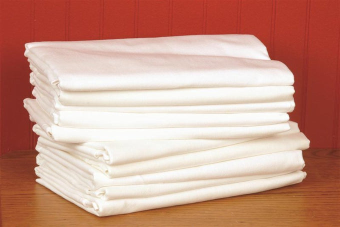 Stack of ten soft, lint-free 100% cotton muslin flour sack towels in natural white, perfect for gentle cleaning tasks in kitchen, household, and homesteading settings.
