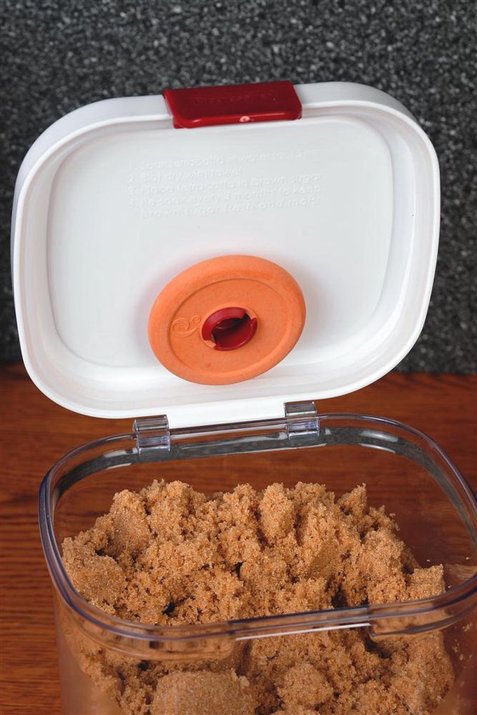Clear rectangular plastic container with a snap-shut white lid featuring a terra cotta moisture regulator, filled with fresh brown sugar, designed for Kitchen & Food, Storage and Serving collections.