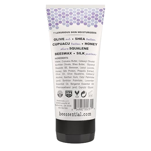 Back view of a 6 fl oz tube of Beessential Hand and Body Cream highlighting natural ingredients like olive oil, shea butter, honey, beeswax, and silk protein, handcrafted in USA, featured in Health & Wellness, Balms, Creams and Lotions, USA Made, Best Sellers, Promo Eligible, and Sale collections.