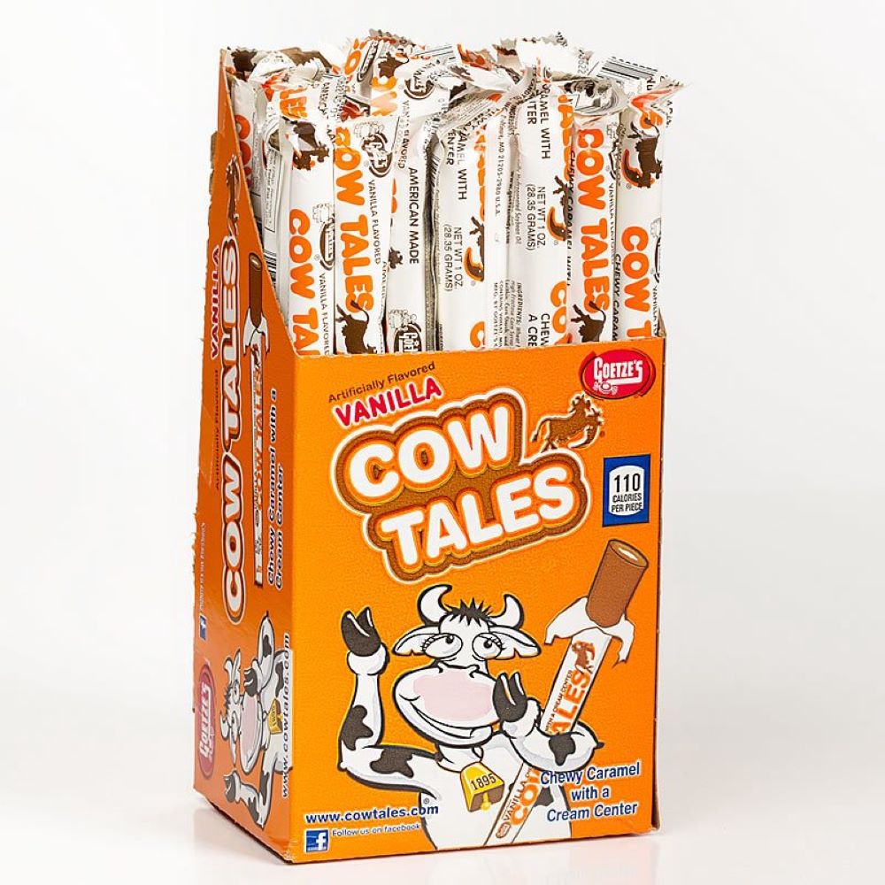 Bright orange box of individually wrapped vanilla caramel chew sticks with a playful cow illustration, made in USA, featured in Snacks and Sweets, Candy, and Best Sellers collections.