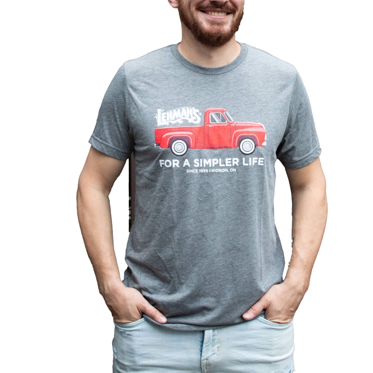 Adult wearing a light gray soft cotton t-shirt featuring a handcrafted bright red vintage truck graphic with Lehman's logo and "For a Simpler Life" text, part of Health & Wellness, Clothing and Accessories, Best Sellers, and Promo Eligible collections.