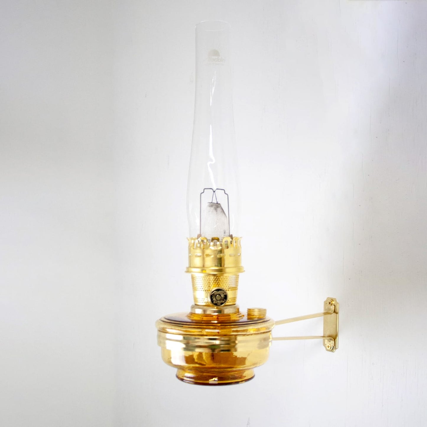 Handcrafted amber glass wall oil lamp with brass mounting bracket, designed for bright, electric-level light and long-lasting use, ideal for Farm, Garden & Tool and Lighting collections.