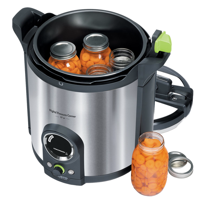Stainless steel digital pressure canner with clear control dial and green handle, shown with jars of preserved carrots, part of Kitchen & Food and Food Preservation collections.