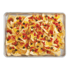 Half size perforated non-stick crisp pan filled with baked nachos topped with melted cheddar cheese, diced tomatoes, jalapeños, and black olives, featured in Kitchen & Food, Cookware, Baking Supplies, Best Sellers, Promo Eligible collections.