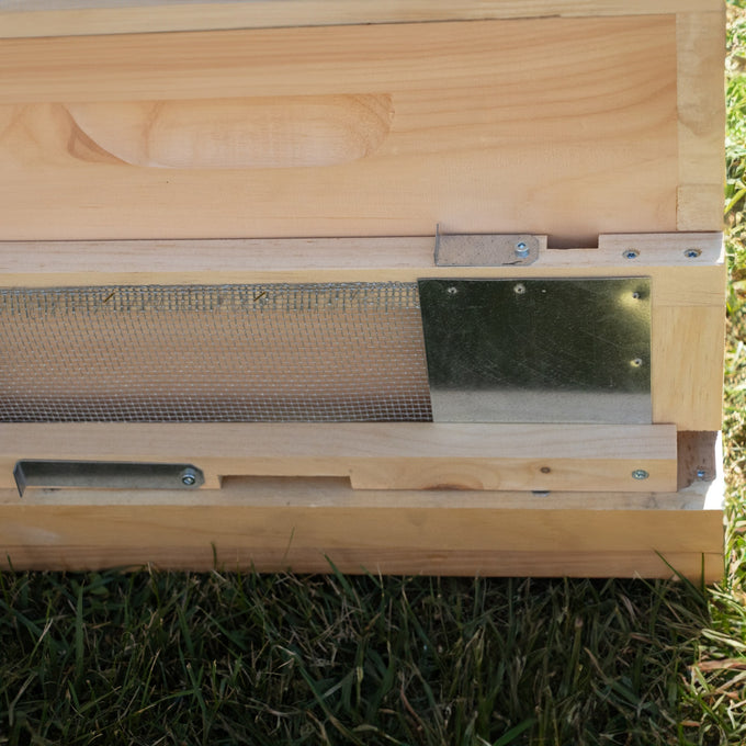 Handcrafted Amish-made wooden beehive screen with metal mesh and adjustable metal latches, designed to control hive entrances and protect against robbing bees, part of Farm and Beekeeping Supplies collections.