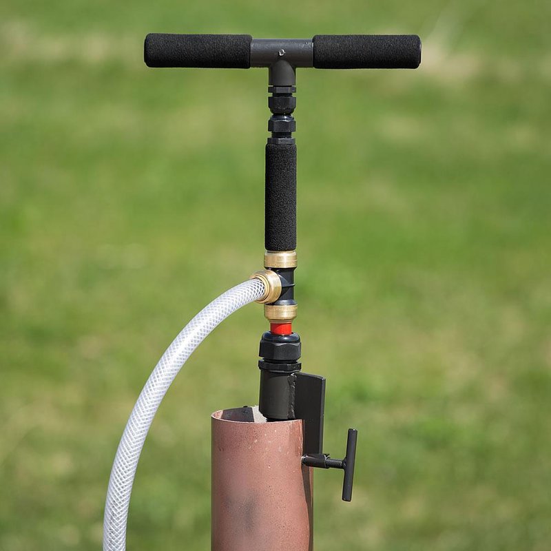 Handcrafted deep well hand pump with black foam handles and attached white hose, designed for easy installation in emergency water supply, made in USA, featured in Farm, Garden & Tool and Emergency Supplies collections.