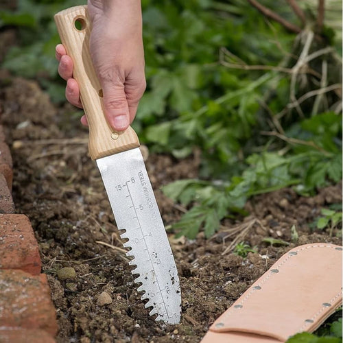 Handcrafted hori hori gardening knife with smooth wooden handle and serrated stainless steel blade featuring measurement markings, used in Farm, Garden & Tool, Digging and Cultivating, Garden Accessories, Best Sellers, and Promo Eligible collections.