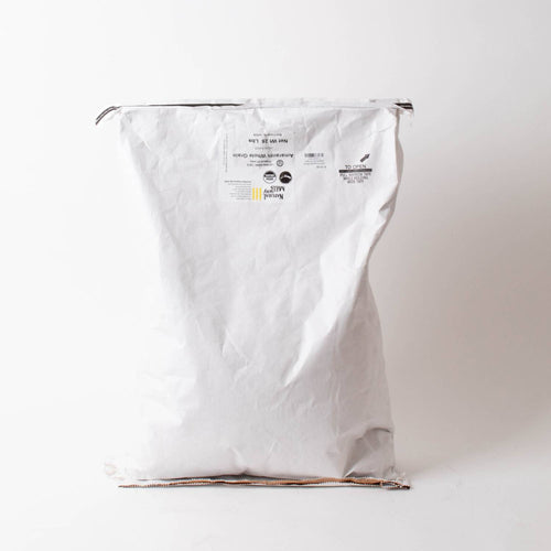 Large white paper sack with printed label containing organic whole amaranth grain, suitable for pantry, emergency supplies, kitchen, and farm collections.