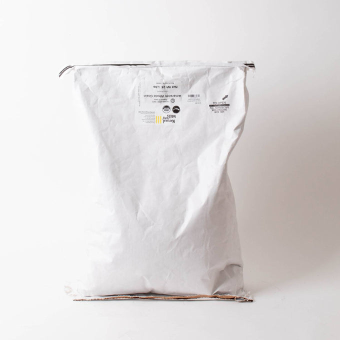 Large white paper sack with printed label containing organic whole amaranth grain, suitable for pantry, emergency supplies, kitchen, and farm collections.