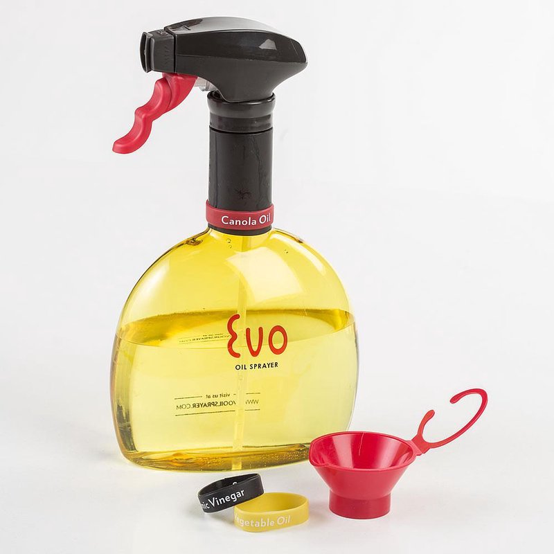 Clear round oil sprayer bottle with black and red spray nozzle, filled with canola oil, accompanied by small red funnel and labeled yellow and black refill caps, featured in Kitchen & Food and Cookware collections.