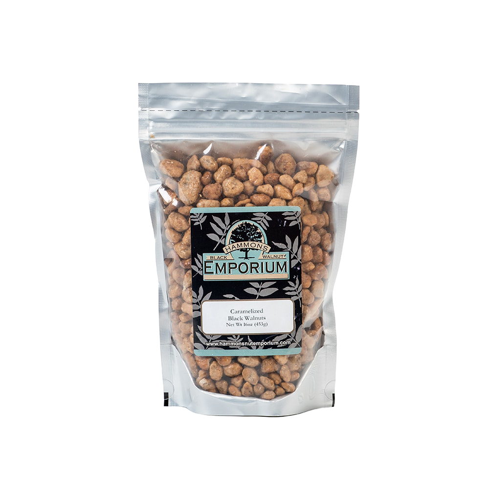 Clear resealable bag filled with caramelized black walnuts coated in a sweet buttery glaze, handcrafted and made in USA, part of Kitchen & Food and Snacks and Sweets collections.