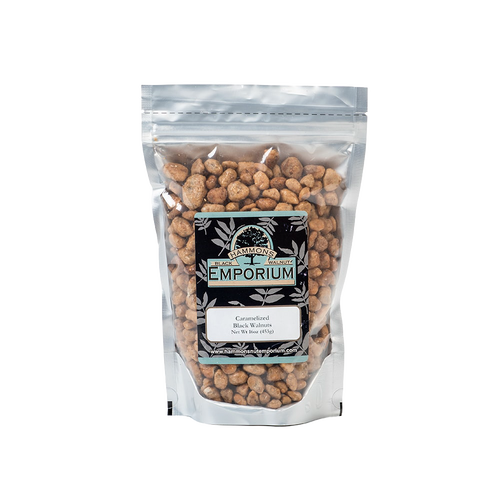 Clear resealable bag filled with caramelized black walnuts coated in a sweet buttery glaze, handcrafted and made in USA, part of Kitchen & Food and Snacks and Sweets collections.