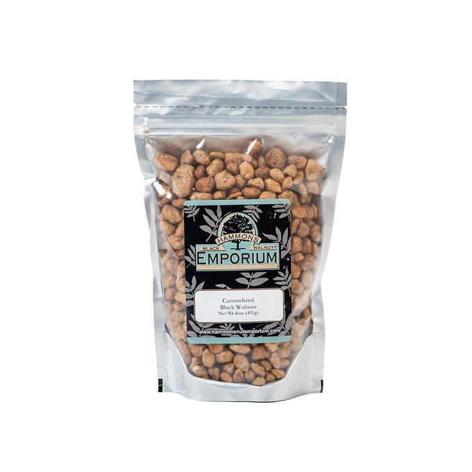 Clear resealable bag filled with caramelized black walnuts coated in a sweet buttery glaze, handcrafted and made in USA, part of Kitchen & Food and Snacks and Sweets collections.
