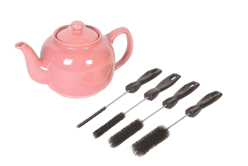 Set of four versatile cleaning brushes with black handles in different sizes, displayed next to a pink ceramic teapot, ideal for household cleaning and home care.