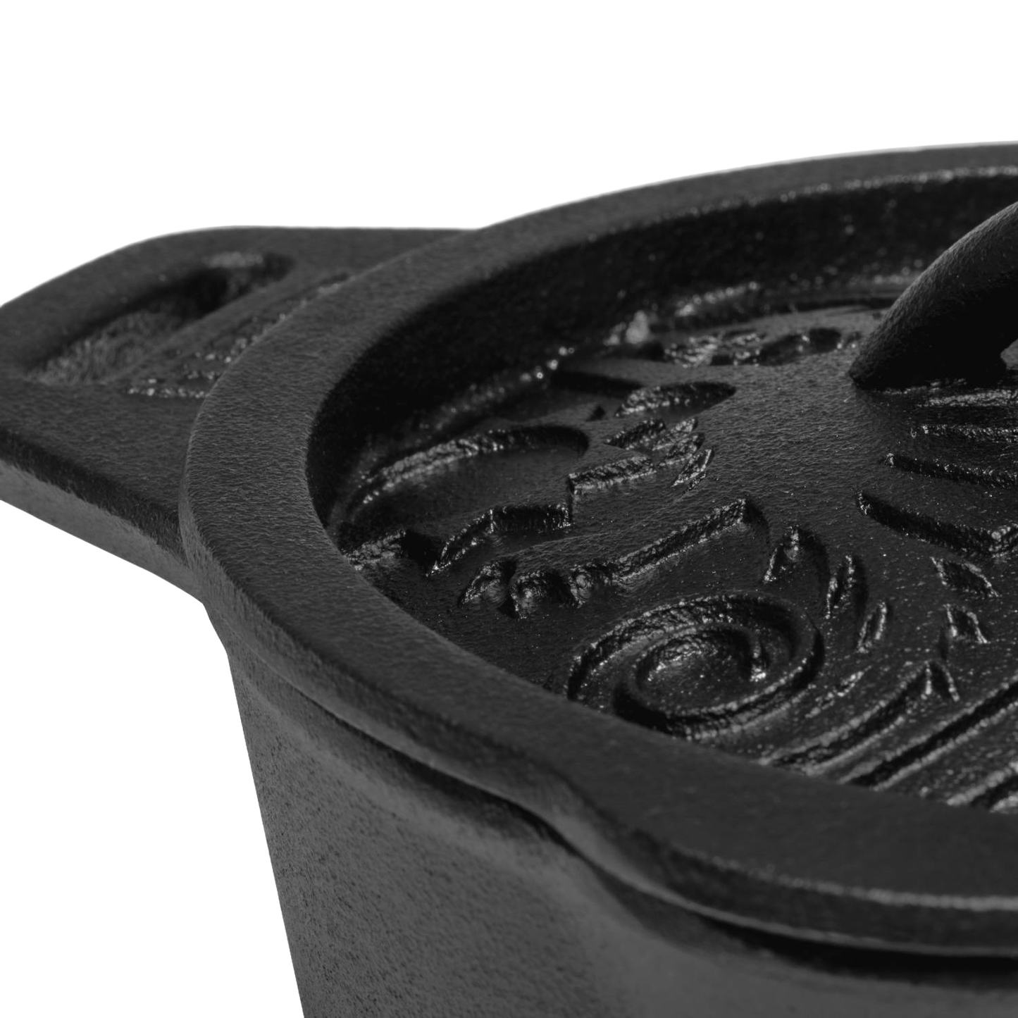 Close-up of a heavy-duty cast iron saucepan lid with raised, embossed self-basting pattern and sturdy handle, crafted for farm, garden, camping, and cookware collections.