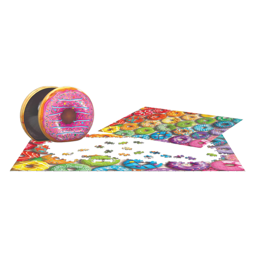 Brightly colored jigsaw puzzle pieces forming a rainbow donut collage next to an embossed metal tin shaped like a frosted donut, ideal for children's toys and puzzles collections.