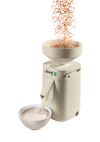 Electric stone grain mill in a smooth beige finish with large open hopper pouring wheat into the mill and fresh flour flowing into a white bowl, featured in Kitchen & Food, Grain Mills, Best Sellers, Promo Eligible, and New collections.