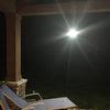 Bright outdoor rechargeable lantern hanging under porch roof, providing glowing light for nighttime camping, backyard, or emergency use, ideal for pest control and outdoor activities.