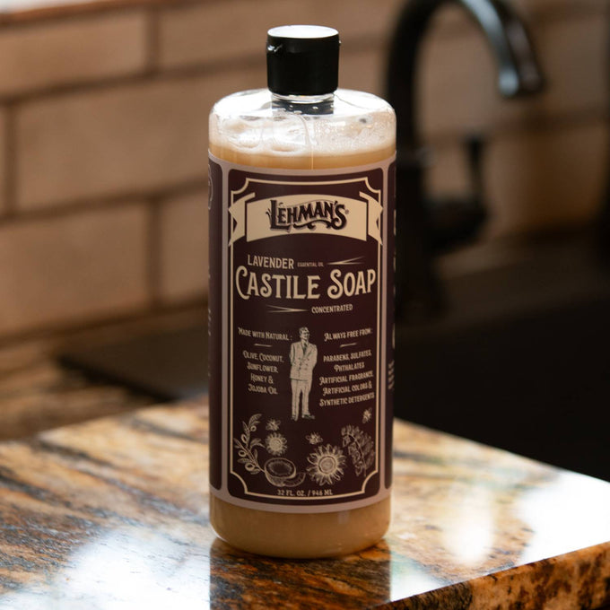 Clear bottle of handcrafted Lehman's concentrated castile liquid soap in lavender scent, featuring plant-based oils, placed on a kitchen counter near a faucet, highlighting natural, multi-use, USA made soap from Health & Wellness, Grooming and Personal Hygiene, Soaps and Soapmaking collections.
