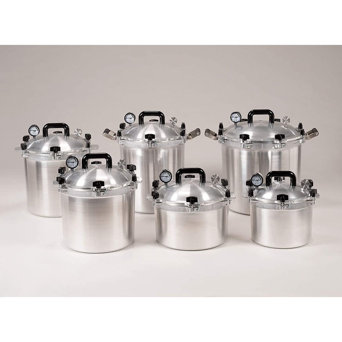 Group of aluminum pressure canners with black handles and built-in pressure gauges, handcrafted in USA, ideal for Kitchen & Food, Food Preservation, and Canning collections.