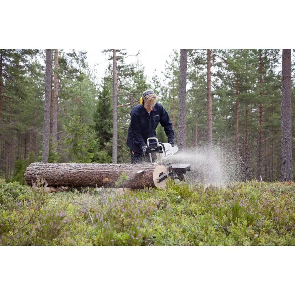Person wearing protective gear operating a portable timberjig sawmill cutting a large log in a forest setting, ideal for Farm, Garden & Tool and Wood Cutting and Hauling collections.
