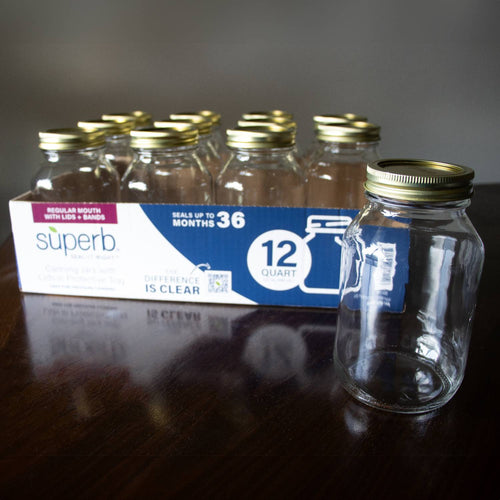 Set of clear regular-mouth glass canning jars with metal lids and bands arranged in a box, designed for durable food preservation, featured in Kitchen & Food, Canning, and USA Made collections.