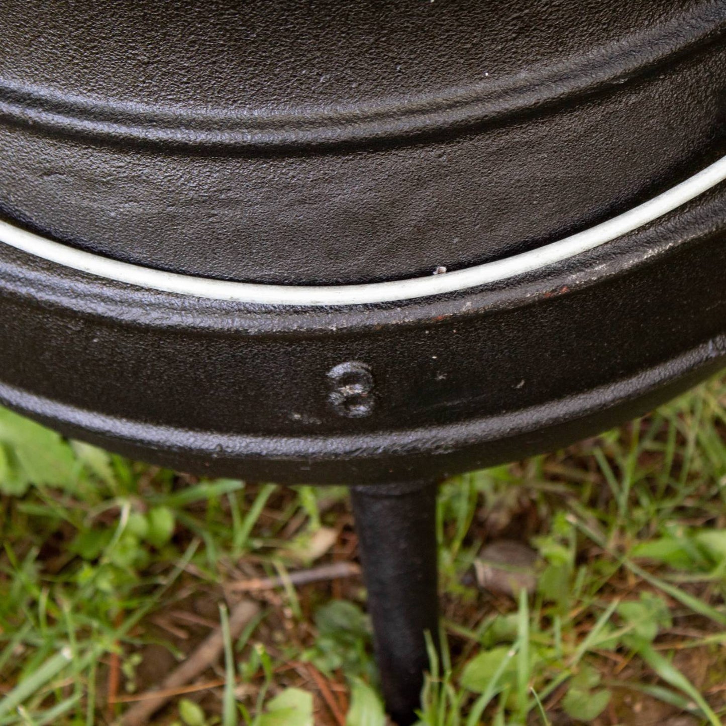 Close-up showing the number 8 embossed on the leg of a handcrafted cast iron campfire kettle, highlighting durable construction for Farm, Garden & Tool, Camping, Best Sellers, and Promo Eligible collections.