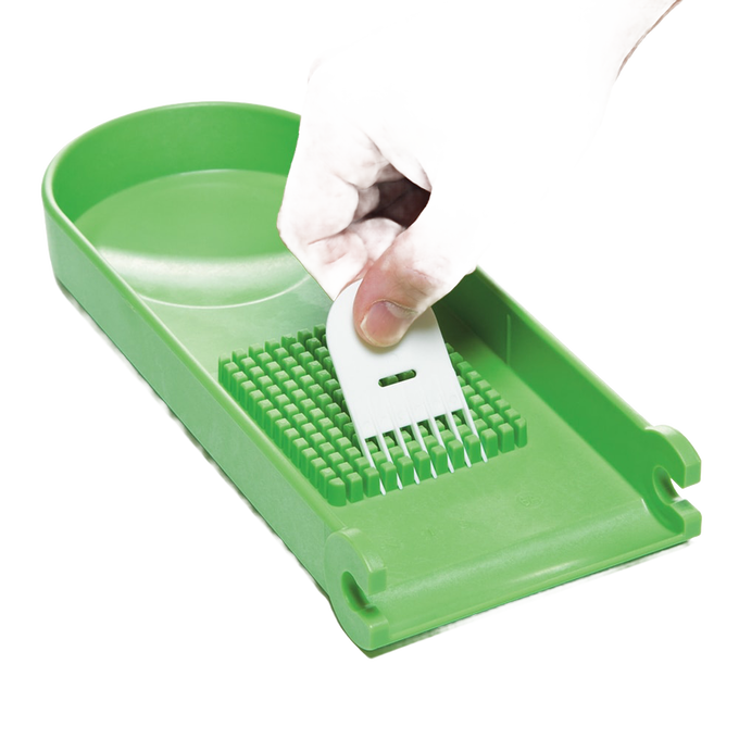 Handcrafted green chopper blade plate held by hand above matching green base, designed for easy vegetable and fruit prep, featured in Kitchen & Food, Food Prep, Choppers and Cutters, Kitchen Gadgets, Kitchen Accessories, Best Sellers, Promo Eligible collections.