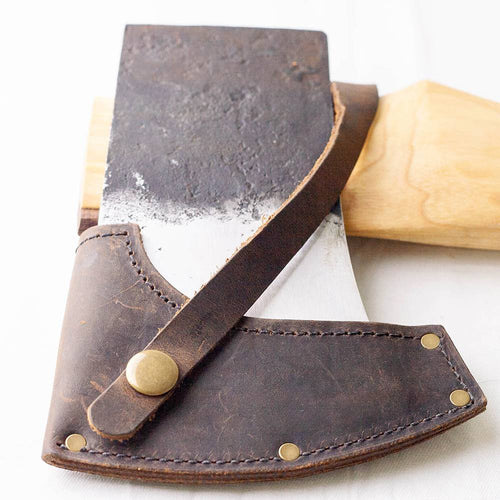 Heavy-duty axe head with a durable leather sheath featuring brass rivets and snap closure, resting on a smooth wooden handle, part of Farm, Garden & Tool and Best Sellers collections.