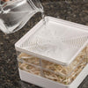 Water being poured into a clear, two-tiered seed sprouter with removable dividers, designed for growing fresh sprouts indoors, featured in Farm, Garden & Tool and USA Made collections.