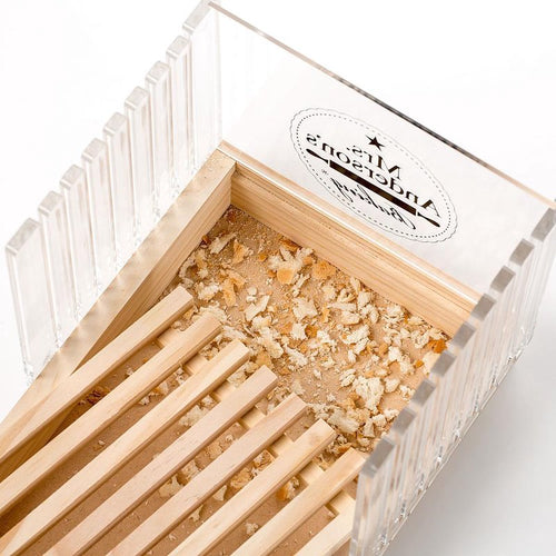 Handcrafted wooden bread slicing guide with clear acrylic panels and a removable crumb tray filled with fresh bread crumbs, featured in Kitchen & Food and Bread Making Supplies collections.