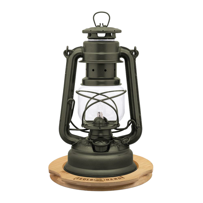 Unique handcrafted metal oil lantern with matte finish, positioned on a bamboo coaster engraved with matching logo, ideal for lamps, camping, emergency supplies, and outdoor use.