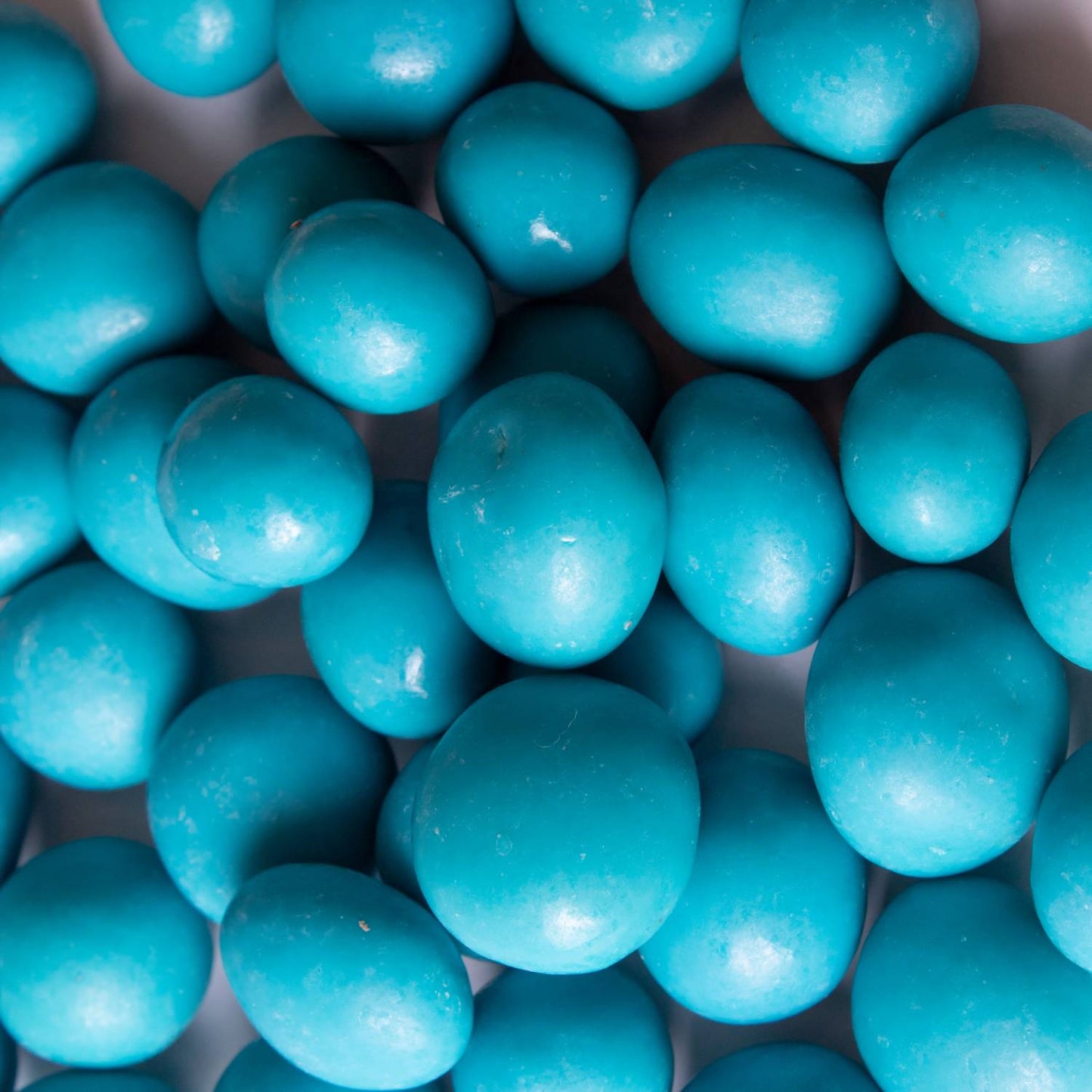 Close-up of vibrant blue handcrafted chocolate-covered blueberries, perfect for Kitchen & Food, Snacks and Sweets, Candy, USA Made, and Best Sellers collections.