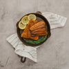 Handcrafted, Amish-made lightweight cast iron skillet holding two seasoned cooked fish fillets, garnished with fresh lemon slices and dill, ideal for Kitchen & Food, Camping, and USA Made collections.