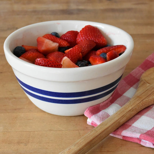 Handcrafted USA-made stoneware bowl with blue stripes, filled with fresh berries, perfect for Kitchen & Food, Baking Supplies, Dinnerware, Storage and Serving collections.