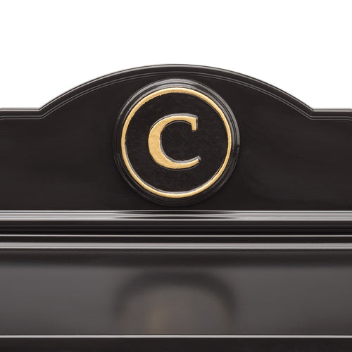 Close-up of a handcrafted black and gold monogrammed detail on a custom wall mount mailbox, made in USA, perfect for Home & Decor, Mailboxes and Address Signs, and Household Helpers collections.