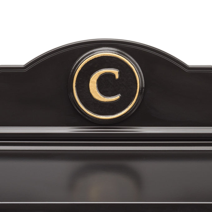Close-up of a handcrafted black and gold monogrammed detail on a custom wall mount mailbox, made in USA, perfect for Home & Decor, Mailboxes and Address Signs, and Household Helpers collections.