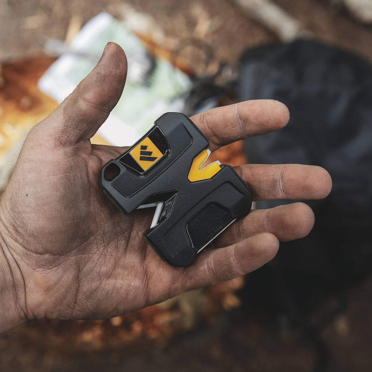 Hand holding a compact Work Sharp Pivot knife sharpener with black and yellow grip, suited for sharpening knives, axes, and tools in Farm, Garden & Tool and Hand Tools collections.