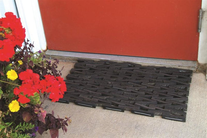 Handcrafted durable doormat woven from recycled tire strips in a traditional herringbone pattern, designed for outdoor use, ideal for Home & Decor, Household Helpers, and Best Sellers collections.