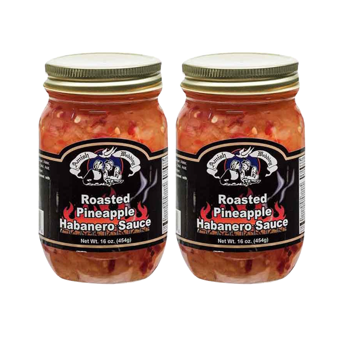 Two jars of roasted pineapple habanero sauce with a black label featuring white text and a graphic, crafted in the USA, ideal for Kitchen & Food and Pantry collections.