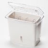 Clear and white fresh-cut herb keeper with removable dividers and refill window, designed to extend herb freshness in kitchen storage and cooking collections.