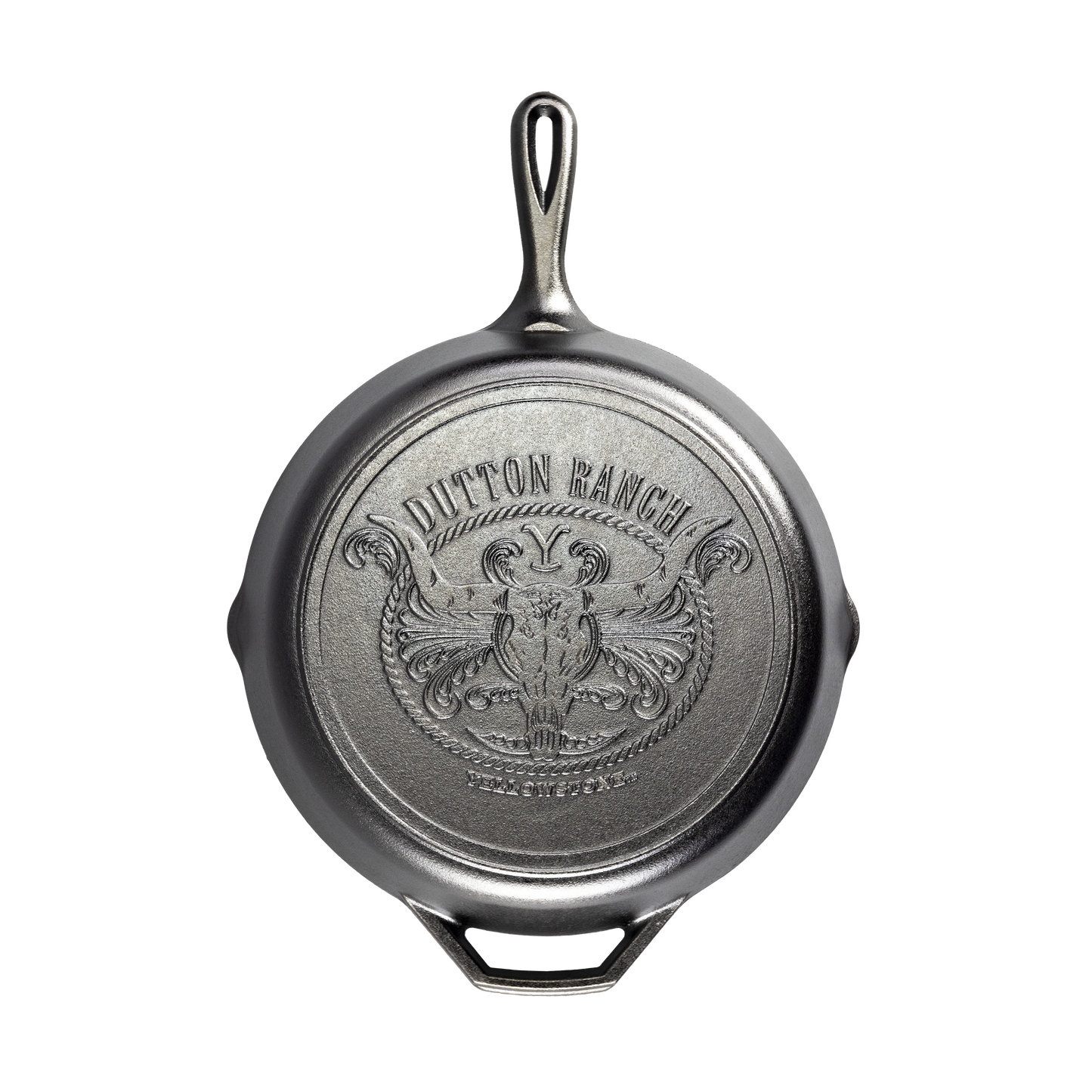 Handcrafted cast iron skillet with a detailed embossed Dutton Ranch steer skull and decorative scroll design on the bottom, made in USA, perfect for Kitchen & Food, Cookware, Cast Iron, USA Made, and Best Sellers collections.