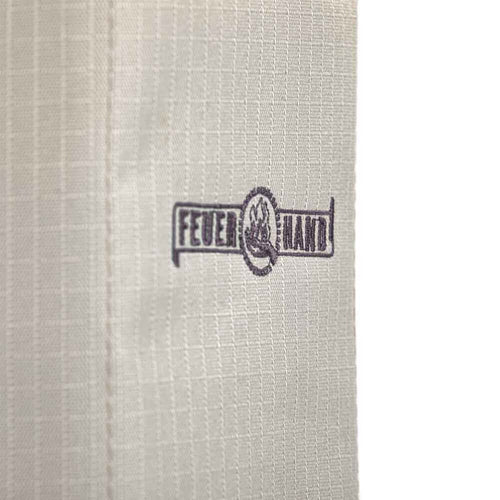 Close-up of textured beige fabric with a stamped logo, part of a durable, weather-resistant lantern transport bag for camping, emergency supplies, and outdoor use.