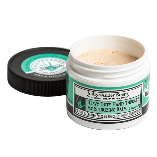 Open container of heavy-duty hand therapy balm with a light beige creamy texture, featuring a white and green label, designed for soothing cracked hands, part of Health & Wellness and USA Made collections.