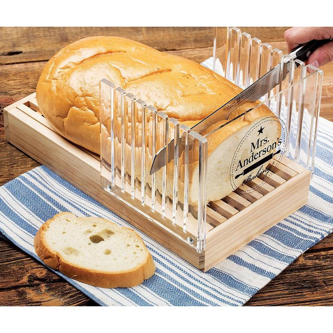 Handcrafted wooden bread slicing guide with clear acrylic panels for precise, even slices and a removable crumb tray, shown cutting fresh bread on a striped towel, ideal for Kitchen & Food and Bread Making Supplies collections.