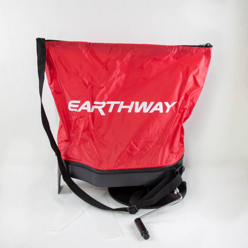 Red nylon seed spreader bag with black base, adjustable shoulder strap, and crank handle, designed for easy scattering of granular materials; part of Farm, Garden & Tool, Seeds and Planting, USA Made, Best Sellers, and Promo Eligible collections.