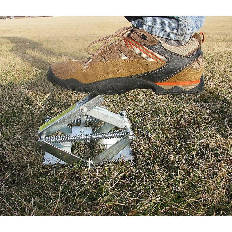 Sturdy metal mole trap set partially underground, demonstrating foot-activated spring mechanism, ideal for Farm, Garden & Tool, Pest Control, and USA Made collections.